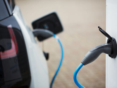electric-car-being-charged-with-a-cable-connected--DGHRCKP